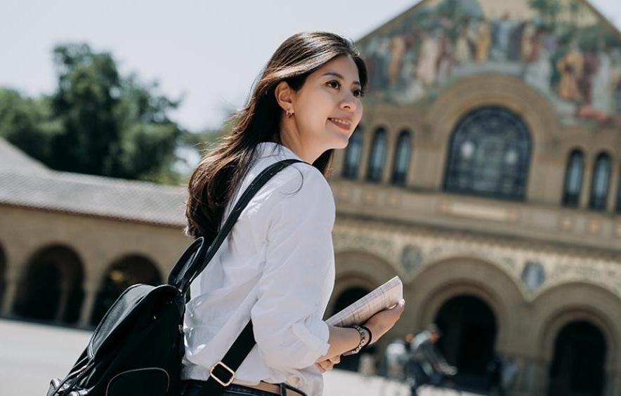 student in front of church